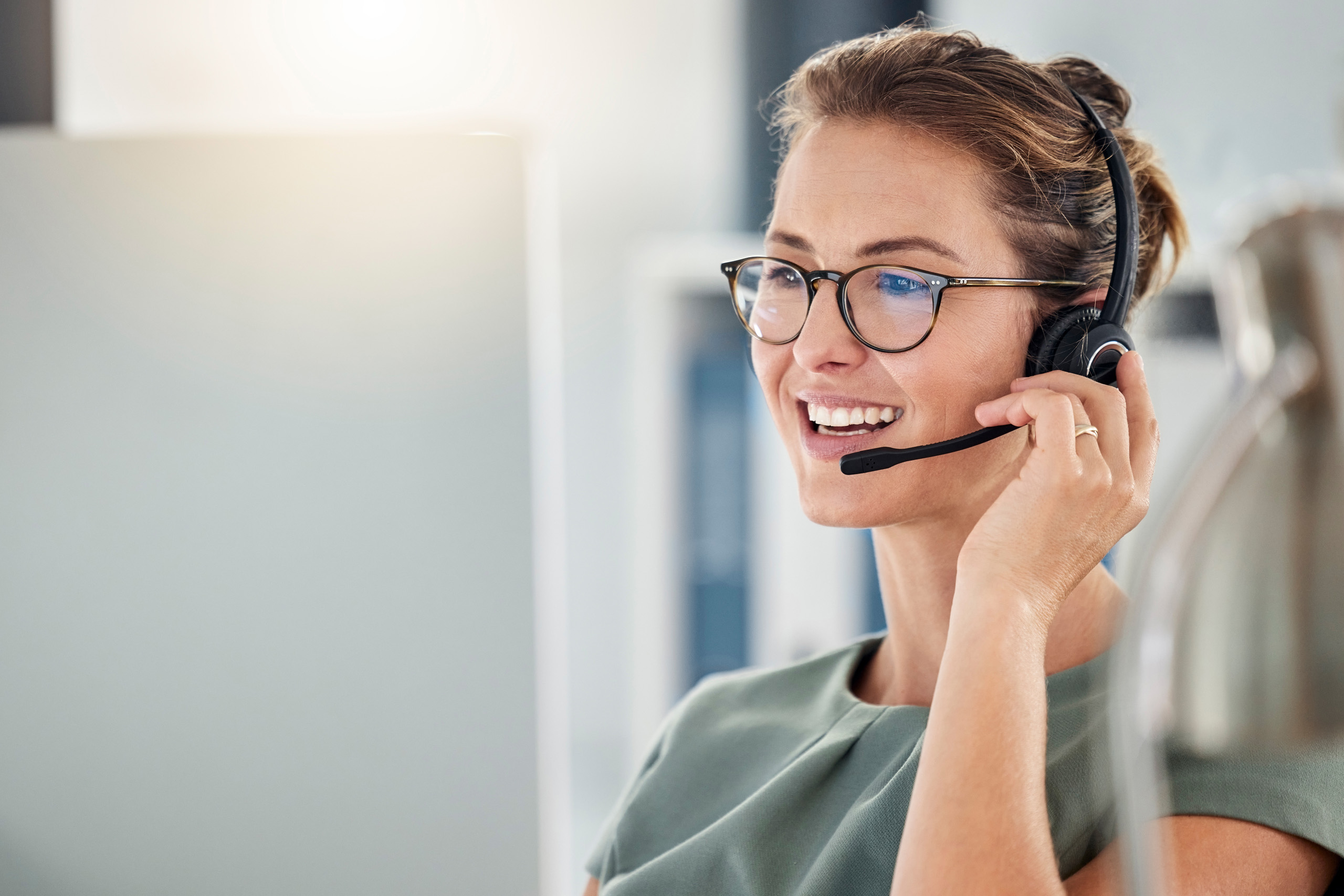 Woman wearing glasses talking into a headset