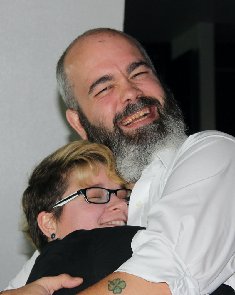 Two people hugging at a charity event