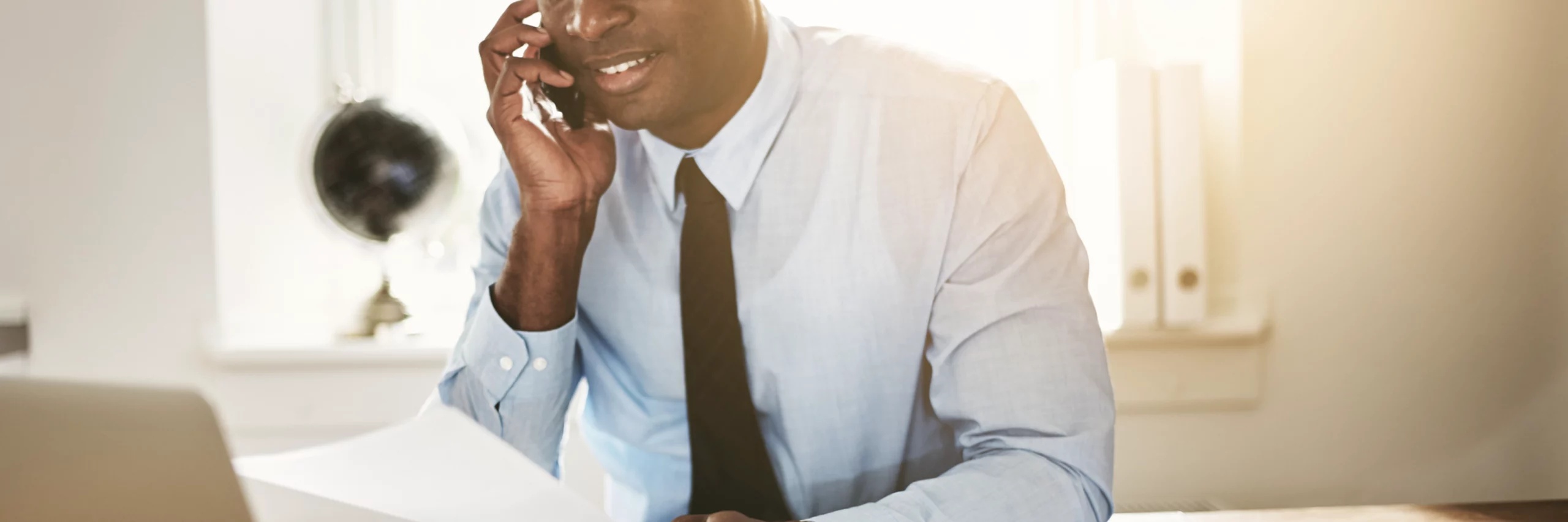 Undistinguishable BIPOC woman wearing a light dress shirt with dark tie
