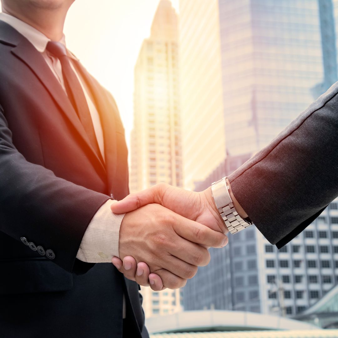 Undistinguishable men shaking hands